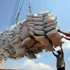 Rice sacks are loaded onto a vehicle for export. (Photo: VNA)