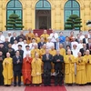 President To Lam (front, seventh from right), religious dignitaries, and officials at the meeting in Hanoi on June 13 (Photo: VNA)