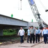 PM Pham Minh Chinh (third from left) and officials examine the construction site of Can Tho - Ca Mau Expressway's section in Hau Giang province on July 12. (Photo: VNA)