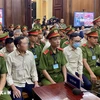 Defendants involved in the Vietnam Register corruption case at the first-instance trial opened in HCM City on July 18. (Photo: VNA)