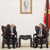 Deputy PM Tran Luu Quang (right) talks to Minister of War Veterans and Rights Holders of Algeria Laid Rebiga at the meeting in Hanoi on July 25. (Photo: VNA)