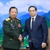 PM Pham Minh Chinh (right) receives General Chansamone Chanyalath, Deputy PM and Minister of National Defence of Laos, in Hanoi on July 25. (Photo: VNA)
