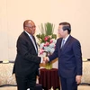 Phan Van Mai (right), Vice Secretary of the Party Committee of HCM City and Chairman of the municipal People’s Committee, welcomes Manuel Domingos Augusto, Politburo member and Secretary of the MPLA Central Committee, on August 22. (Photo: VNA)