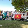 Vietnamese students pose for a group photo at the graduation ceremony on August 29. (Photo: VNA)