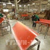 Workers put final touches on wood planks for export at a factory in An Dien commune of Ben Cat district, Binh Duong province. (Photo: VNA)