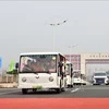 Electric vehicles carrying tourists cross Bac Luan II Bridge, part of the Mong Cai (Quang Ninh, Vietnam) - Dongxing (Guangxi, China) international border gates. (File photo: VNA)