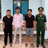 The three men (left) are arrested while attempting to exit Vietnam illegally. (Photo: VNA)