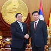 Vietnamese Prime Minister Pham Minh Chinh (left) meets with General Secretary of the Lao People’s Revolutionary Party Central Committee and President of Laos Thongloun Sisoulith in Vientiane on October 8. (Photo: VNA)