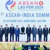 Vietnamese PM Pham Minh Chinh (fifth from left), leaders of other ASEAN countries, and Indian PM Narendra Modi (sixth from left) pose for a group photo at the 21st ASEAN - India Summit in Vientiane on October 10. (Photo: VNA)