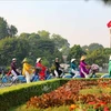 "Ao dai" wearers cycle near the Flag Tower of Hanoi. Vietnam sees the biggest improvements in diplomatic influence and cultural influence in the Asia Power Index 2024 rankings. (Photo: VNA)