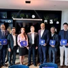 Representatives of the Hai Phong People’s Committee and the Canadian - ASEAN Business Council pose for a photo after singing a letter of intent. (Photo: VNA)