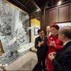 Amandine Dabat (in red), a fifth-generation descendant of King Ham Nghi, and officials of Thua Thien-Hue province visit an exhibition on the king. (Photo: VNA)