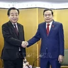 NA Chairman Tran Thanh Man (right )and President of the Constitutional Democratic Party of Japan Noda Yoshihiko at their meeting in Tokyo on December 6 (Photo: VNA)