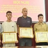 Quatre hommes sont honorés pour avoir sauver des victimes de l'incendie survenu le 24 mai à Hanoï. Photo: VNA