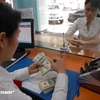 Le taux de change devrait réduire la fin de l'année, selon les experts de l'UOB. Photo: Vietnamplus