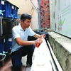 Nguyên Tuân Anh vérifie la décomposition des bouteilles de solution pour créer un engrais organique microbien. Photo : VNA/CVN