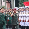 Sen. Lt. Gen. Nguyen Tan Cuong (L) and General Tan Sri Datuk Seri Mohammad bin Ab Rahman inspect the guard of honour (Photo: VNA)