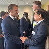 Deputy Prime Minister and Foreign Minister Bui Thanh Son (R) meets French President Emmanuel Macron on September 25. Photo: VNA