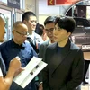 A police officer reads arrest warrant to Warathaphon “Boss Paul” Waratyaworrakul, CEO of Icon Group, at the Office of the Consumer Protection Board. (Source: Central Investigation Bureau)