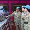 Female soldiers visit the photo exhibition (Photo: VNA)