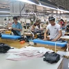 Suits are produced for export at Kad Industrial.S.A Vietnam Company in the Hoa Khanh Industrial Zone of the central city of Da Nang (Photo: VNA)