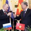 President To Lam (R) hosts a banquet in Hanoi on June 20 evening in honour of Russian President Vladimir Putin. (Photo: VNA)