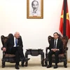 Deputy Prime Minister Tran Luu Quang (R) receives Donald McKinnon, special envoy of the New Zealand Government in Hanoi on July 25. (Photo: VNA)