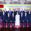 Participants pose for a group photo at the banquet. (Source: VNA)