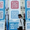 A jobseeker passing by banners imbued with QR codes of overseas job vacancies during a job fair in Sukabumi City, West Java, on August 29, 2024. (Photo: ANTARA FOTO/Henry Purba/agr/rwa)