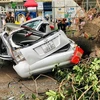 A car crushed by fallen tree in front of HH Building, Linh Dam urban area, Hanoi (Photo: VNA)