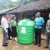 One of the 456 plastic water storage tanks is presented to a local in Cao Bang (Photo: VNA)