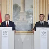 Vietnam’s Party General Secretary and State President To Lam (L) and French President Emmanuel Macron at a press briefing before their talks in Paris on October 7. (Photo: VNA)