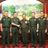 From left: Vietnamese Deputy Minister of National Defence Sen. Lieut. Gen Hoang Xuan Chien (2nd) and Lao Deputy Prime Minister and Minister of National Defence Gen. Chansamone Chanyalath (3rd) in a group photo at their meeting in Vientiane on October 10. (Photo: VNA)