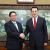 Visiting Prime Minister Pham Minh Chinh (L) and Yuan Jiajun, Politburo member of the Communist Party of China (CPC) Central Committee and Secretary of the Chongqing Municipal Party Committee, at their meeting on November 8. (Photo: VNA)