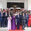 General Secretary of the Communist Party of Vietnam Central Committee To Lam (first row, second from right) and his spouse (first row, second from left) in a group photo with the embassy's staff and representatives of the Vietnamese community in Malaysia at the meeting. (Photo: VNA) 