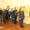 Delegates perform flag-saluting ceremony at the event (Photo: VNA)