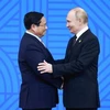 El presidente ruso, Vladimir Putin (derecha), presidente del BRICS 2024, recibe al primer ministro Pham Minh Chinh. (Foto: VNA)