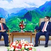 Prime Minister Pham Minh Chinh (R) receives visiting President of the Lao State Inspection Authority Khamphan Phommathat at their meeting in Hanoi on June 3. (Photo; VNA)