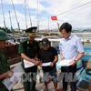 Des gardes-frontières de la province de Binh Dinh inspectent les bateaux de pêche. Photo: VNA