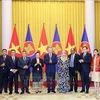 President To Lam (sixth from right) and diplomats (Photo: VNA)