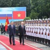 President To Lam (left) and President Vladimir Putin review the Honour Guard of the Vietnam People's Army in Hanoi on June 20. (Photo: VNA)