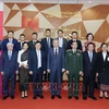 President To Lam (middle, first row) takes a group photo with representatives of Star Telecom (Unitel) as part of his state visit to Laos on July 11. (Photo: VNA)