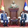 Vietnamese President To Lam (left) and Chairman of the Lao National Assembly Saysomphone Phomvihane at their meeting in Vientiane on July 11. (Photo: VNA)