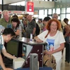 Passengers check in for flights at Noi Bai International Airport (Photo: VNA)
