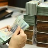 The central bank is ready to restructure debt to back business recovery. (Photo: VietnamPlus)