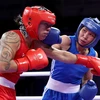 Ha Thi Linh of Vietnam (right) lands a punch on Feofaaki Epenisa from Tonga during the Paris Olympics' women's 60kg first round match on July 27. (Photo: doisongphapluat.com.vn)