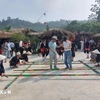 Travellers experience traditional dances at a community-based tourism site in Ba Vi district of Hanoi (Photo: VNA)