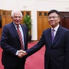 Deputy Prime Minister Le Thanh Long (R) receives EC Vice President Josep Borrell Fontelles (Photo: VNA)