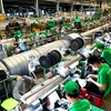 A company in HCM City. With new orders rising sharply, manufacturers ramped up production in July. (Photo: VNA)