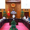 Prime Minister Pham Minh Chinh speaks at the meeting in Hanoi on August 14. (Photo: VNA)